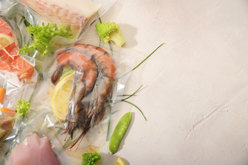 Sous Vide cooking concept. Vacuum packed ingredients arranged on light background. Top View.