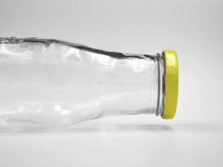 Empty bottle of glass with yellow lid