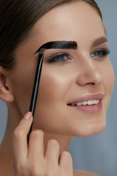 Eyebrow Coloring. Woman Applying Brow Tint With Makeup Brush