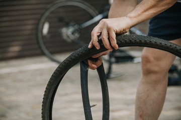 Hands take camera out of  bicycle tire