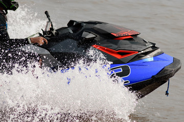 Naklejka premium Water jet ski riding on the lake in sunny day.