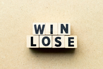Letter block in word win lose on wood background (Concept of game theory)