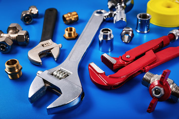 plumbing tools and fittings on blue background