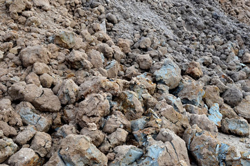 Large pieces of stone clay at the bottom of a mining quarry of minerals, background structure, abstraction