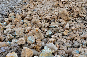 Large pieces of stone clay at the bottom of a mining quarry of minerals, background structure, abstraction