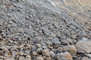 Large pieces of stone clay at the bottom of a mining quarry of minerals, background structure, abstraction