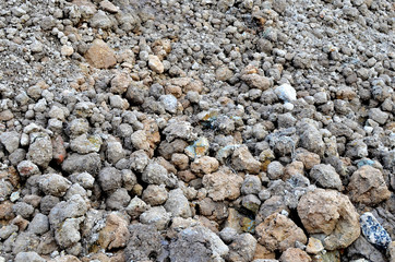 Large pieces of stone clay at the bottom of a mining quarry of minerals, background structure, abstraction