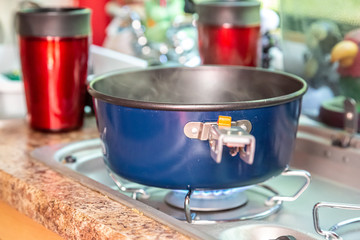 Cooking dinner in a teardrop camper kitchen