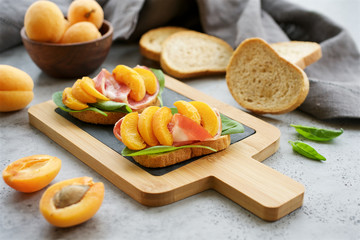 Open sandwich with ham and peach slices. Close up view