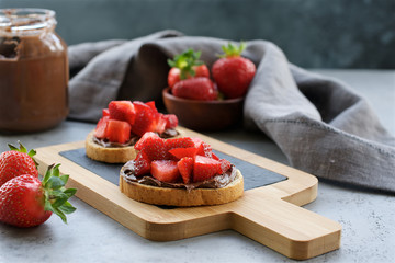 Toasts with chocolate spread and strawberries. Delicious breakfast or snack