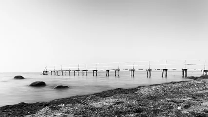 Wall murals Black and white Long exposure side view of a wooden bathing jetty in monochrome