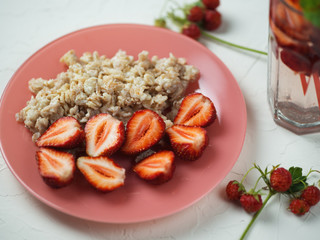 Healthy and tasty Breakfast . Oatmeal with strawberries and strawberry lemonade