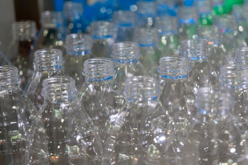 Close-up of the PET bottles on the conveyor belts. The plastics bottle products for drinking water container.