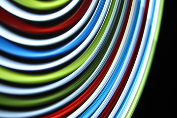 Rainbow LED light spinning on long exposure shot in the dark.