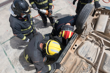 Firemen doing rescue practices in traffic accidents