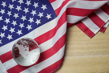 United states flag with crystal glass globe on wood background, 4th of July concept