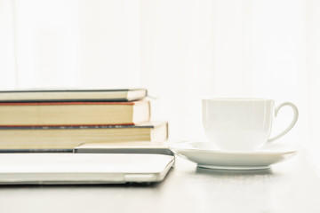 Coffee cup and book on table