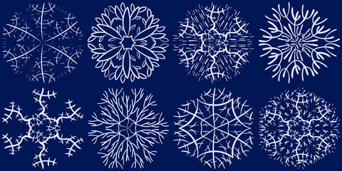 Fototapeta na wymiar Set of snowflakes in the style of hand-drawing on a dark blue background. Elements for design and decoration of greeting cards, Christmas invitations.