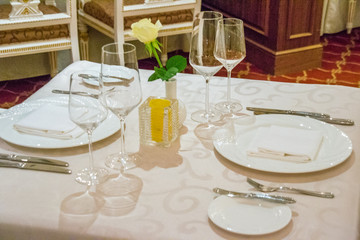 beautiful french restaurant interior with crystal chandeliers and table seating with china porcelain tableware