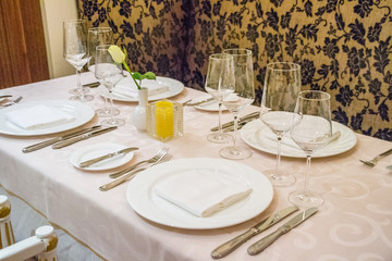 beautiful french restaurant interior with crystal chandeliers and table seating with china porcelain tableware