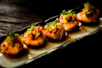 Daily-caught sea shrimp, pan-seared with chilli and topped with warm salsa on a crispy plantain coracle