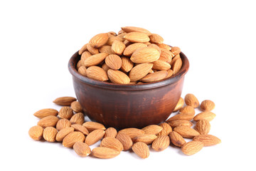 Almonds in bowl isolated on white background