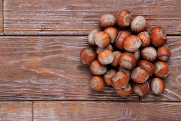 Ripe hazelnuts on brown wooden table