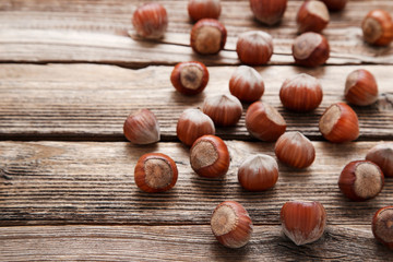 Ripe hazelnuts on brown wooden table