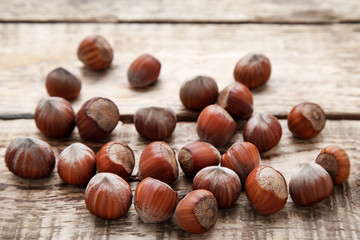 Ripe hazelnuts on brown wooden table