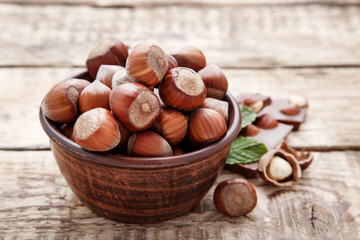 Hazelnuts in bowl on wooden table