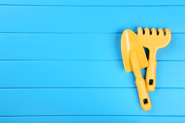 Plastic beach toys on blue wooden table