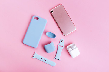 Up to date technology.Top view of diverse personal accessory laying on the pink background
