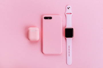 Up to date technology.Top view of diverse personal accessory laying on the pink background