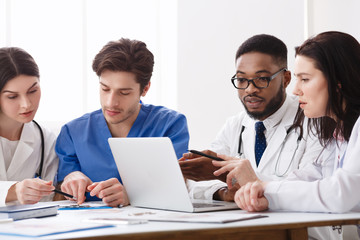 Medical Team Meeting In Hospital And Discussing Treatment Questions