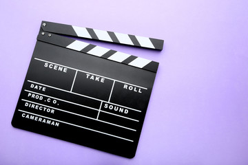 Clapper board on purple background