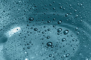 Water drops on a glass background texture. Droplets on a transparent surface.