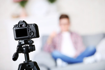 Young boy sitting on sofa and records video