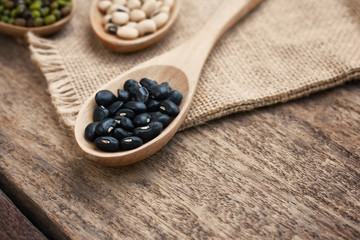 Health food and Eat healthy with legumes in wooden spoon on wooden table. Nutrition high protein diet.