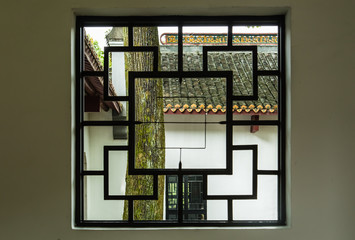 Chinese traditional style wood window in green garden