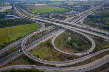 aerial view interchange freeway overpasses and motorway ring road connecting in the city transportation logistics concept in Thailand