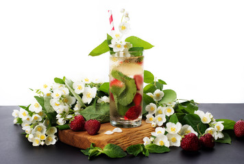 Summer cooling non-alcoholic cocktail. Green tea, strawberries, mint leaves, lime, ice. White...