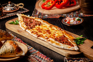 Traditional Turkish cuisine. Turkish pizza Pita with a different stuffing, meat, cheese, slices of...