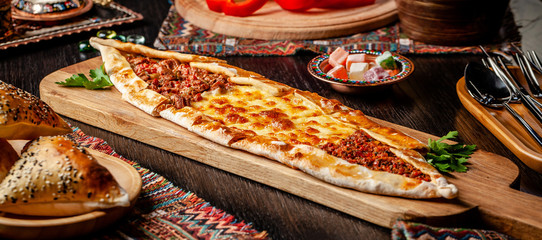 Traditional Turkish cuisine. Turkish pizza Pita with a different stuffing, meat, cheese, slices of...