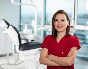 Fototapeta premium Portrait of female dentist standing in her office