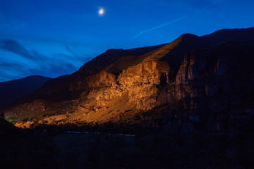 View of Vardzia caves at night. Vardzia is a cave monastery site in southern Georgia, excavated from the slopes of the Erusheti Mountain on the left bank of the Kura River.