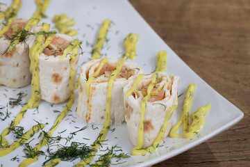 salmon rolls with mayonnaise and dill.