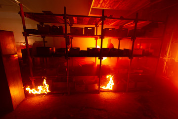 A film crew on a set, a burning factory.