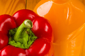 fresh red paprika, bell pepper and a bottle of pumpkin juice