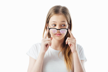 teenage girl touching glasses and looking away isolated on white