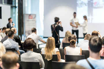 Young business team receiving award prize at best business project competition event. Business and...